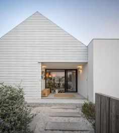 a white house with stairs leading up to the front door