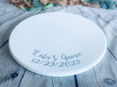 a white frisbee sitting on top of a wooden table