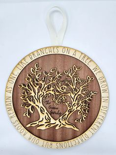 a wooden ornament with an engraved tree on it