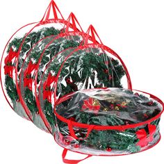 christmas wreaths wrapped in plastic with red ribbons