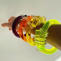 The Knot Bangle is a collection of contemporary acrylic design inspired by its symbolism of love, connection and binding. It also symbolizes good luck, protection and liberation. Each piece is unique and this bangle is a limited edition inspired by the colors of the sunset, it brightens any season! It's perfect with black outfits! 100% Clear Acrylic | Handcrafted Bold Adjustable Bracelets For Party, Adjustable Bold Bracelet For Parties, Bold Adjustable Party Bracelet, Adjustable Bold Party Bracelet, Bold Bangle Jewelry As A Gift, Bold Bangle Jewelry For Gifts, Bold Bangle Jewelry Gift, Adjustable Contemporary Cuff Bracelet, Modern Multicolor Cuff Bangle Bracelet