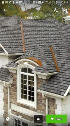 an image of a house that is showing the roof shingles and window trims