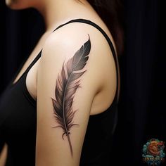 a woman with a tattoo on her arm and a feather in the middle of her arm