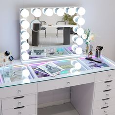 a desk with a lighted mirror and drawers