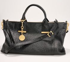 Make this soft leather beauty your everyday handbag. Goldtone accents elevate this casual style. The lined interior features multiple pockets for organization, and the dangle accessory provides a glam finishing touch. From Vince Camuto. Fall 2024 Handbag Trends, Classy Handbags For Women, Quiet Luxury Fashion, Handbags Trendy, Soft Leather Purse, Vince Camuto Bag, Trendy Purses, 2023 Wishlist, Everyday Handbag