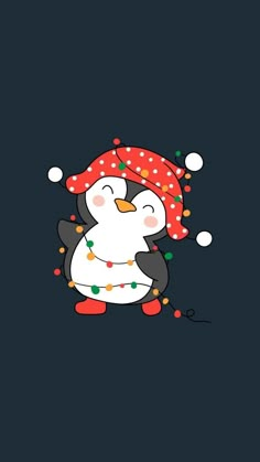 a penguin with a red hat on its head and lights around it's neck