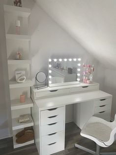 a white desk topped with a mirror and a chair