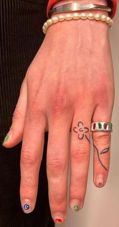 Ink Embrace Artistry on the Hand : Flower Tattoo on Fourth Finger Connecting Finger Tattoos, Tattoo Ideas Trending, Edge Of Hand Tattoo, Small Flower Finger Tattoo, Useful Tattoos Ideas, Hand Piercing Fingers, Pinky Finger Tattoos For Women, Cool Simple Tattoos For Women, Green Thumb Tattoo