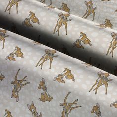 the fabric is printed with deers and dots on white polka dotty background, as well as an animal - like pattern