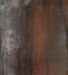 an old rusted metal surface with some paint on it