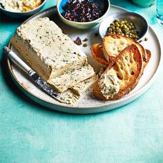 a plate with bread, crackers and other food on it