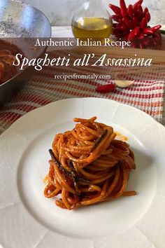 spaghetti with tomato sauce on a white plate