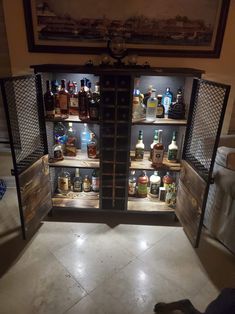 an open refrigerator filled with lots of liquor bottles