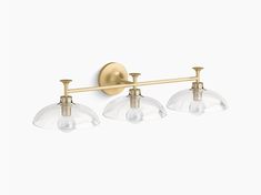 three light brass bathroom fixture with clear glass shades