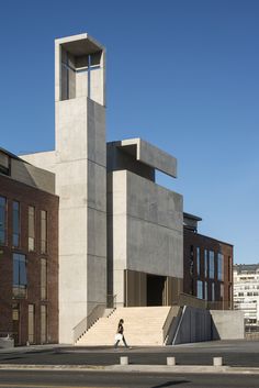 a person walking down the street in front of a building