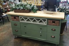 a green dresser with some plants on top