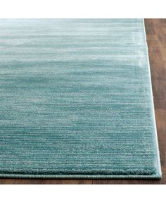 a blue rug on top of a wooden floor