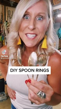 a woman is holding spoons in front of her face with the words diy spoon rings on it