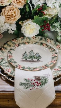 a table topped with plates covered in flowers