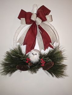 Dark red and white sparkly ribbons, white owl with pinecones and pine branches. Owl Christmas, Pine Branches, Christmas Owls, White Owl, Beaded Christmas Ornaments, Pine Branch, Door Wreath Hanger, Christmas Wreath, Pine Cones