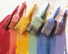 five paintbrushes are lined up in different colors