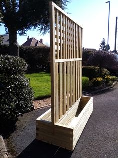 a wooden bench sitting on the side of a road