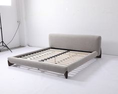 the bed frame is made up and ready to be used as a photo shoot prop