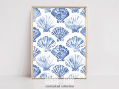 a blue and white shell print on a wall