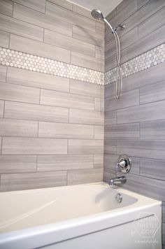 a white bath tub sitting next to a shower head