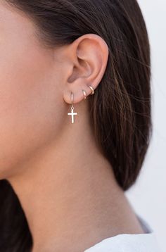 The Croix earrings are small hoops with a cross-shaped pendant. This minimalist and easy-to-combine earrings are really comfortable due to their lightness. They look great on both adults and children. Perfect for a gift, too. Features: * Inner diameter: 9 mm. * Outer diameter: 11 mm. * Cross length: 13 mm. * They are sold in singles and in pairs. Both options are available on the dropdown menu. * All of our jewelry is made with sterling silver (925 mm) and our gold jewelry is gold plated in 18K Earrings Cross, Tiny Hoop Earrings, Hammered Hoop Earrings, Peridot Earrings, Crescent Moon Earrings, Earrings Hoop, Cross Earrings, Moon Earrings, Purple Wedding