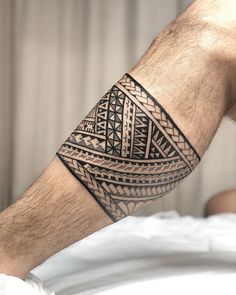 a man's arm with an intricate tattoo design on his left forearm and hand