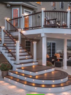 an image of a house with stairs and lights on the outside wall, as well as steps leading up to the second floor