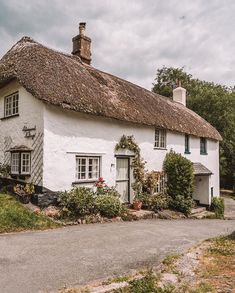 a white cottage with a thatched roof