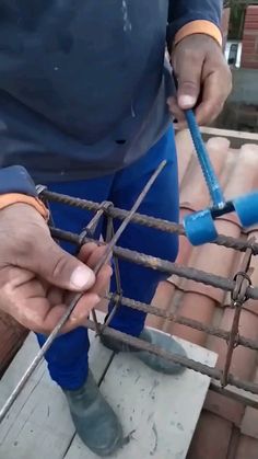 a man is working on some kind of roofing system with tools in his hands