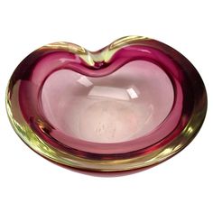 a heart shaped glass bowl sitting on top of a table