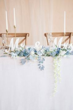 the table is decorated with flowers and candles