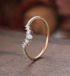 a diamond ring sitting on top of a wooden table