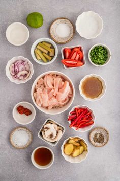 bowls filled with different types of food sitting on top of a gray surface next to each other