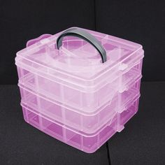 a plastic storage box with handle on the top and bottom lid, sitting on a black surface