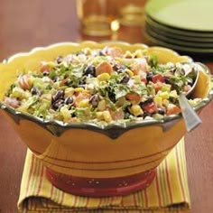 a bowl filled with salad sitting on top of a table