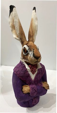 a figurine of a rabbit dressed in a purple suit