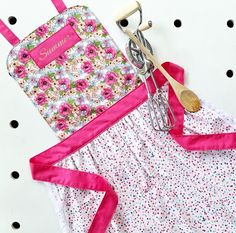 an apron and utensils are sitting next to each other on a polka dot tablecloth