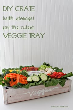 a wooden box filled with vegetables on top of a white table next to a sign that says diy crate with storage from the cute veggie tray