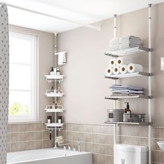 a bathroom with a tub, toilet and shelves in the wall next to the bathtub