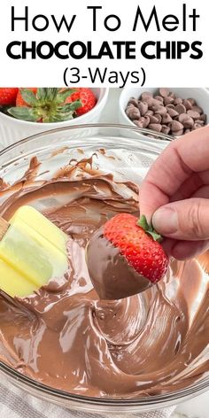 someone dipping chocolate into a bowl with strawberries