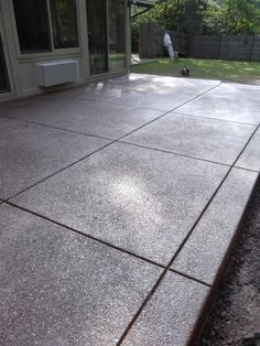 a concrete patio with a sliding glass door