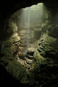 the light shines in from behind a cave entrance