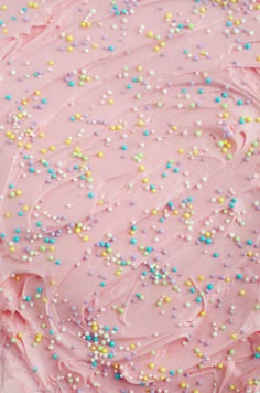 pink frosted cake with sprinkles on top