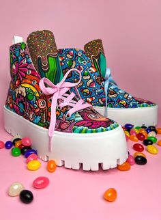 a pair of colorful shoes sitting on top of a pile of gummy bears next to candy