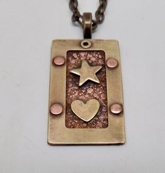 "Awesome mixed metal steampunk necklace . The size is 1 1/4\" by 3/4 \" and it has 24\" antique brass chain. I patina the body to give it a vintage look and the I sealed it to prevent tarnishing. All my jewelry come in a nice gift box." Metal Jewelry Riveting, Riveting Jewelry Ideas, Mixed Metal Pendants, Stamped Brass Pendant Necklace, Steampunk Brass Necklaces For Gifts, Vintage Silver Electroformed Necklaces, Bronze Patina Necklace For Gift, Vintage Metal Necklace With Patina, Steampunk Brass Jewelry In Bronze